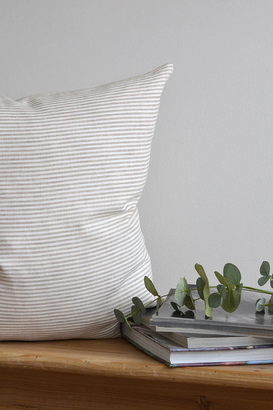 Luxurious and soft to the touch this beautiful linen pillow cover is made from the finest Oeko-Tex certified 100% European linen. The thin vertical stripes on this classic pillow cover will add interest to any room. The neutral tones work with any decor. Designed and crafted in Canada it is easy to care for with a zipper closure and machine washable. Size is 22" x 22" Inserts not included