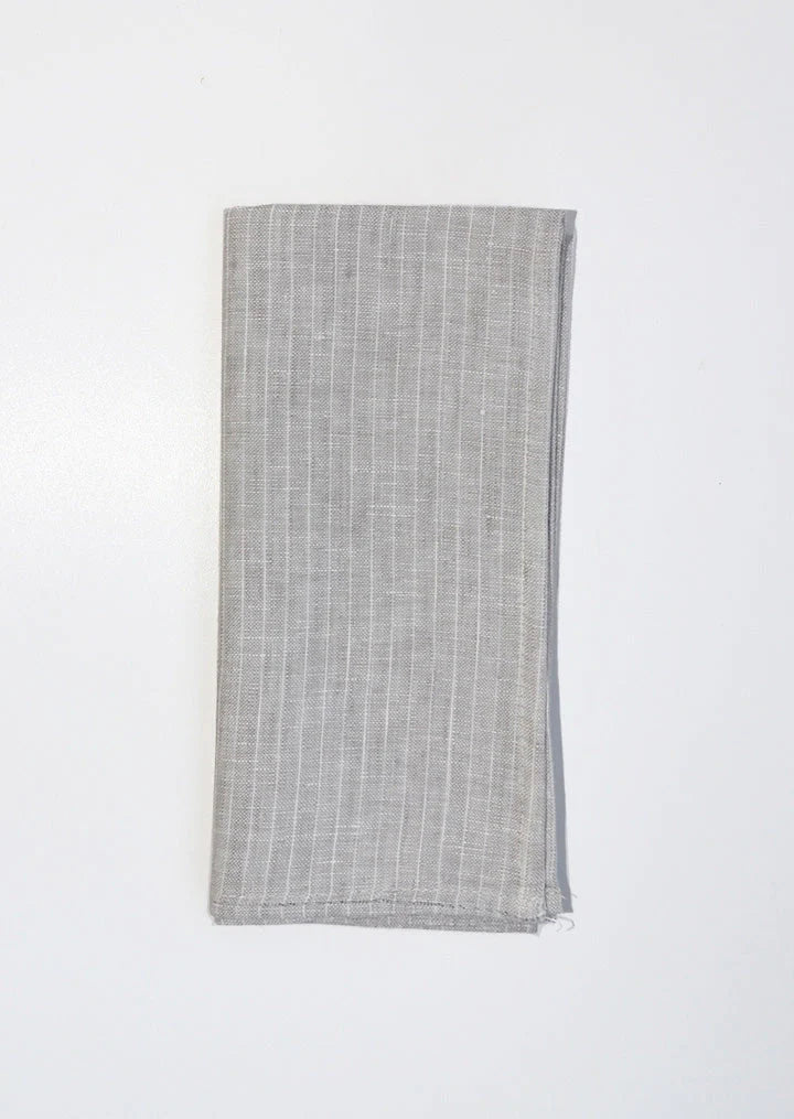 Beautifully crafted in Oeko-Tex linen, these soft grey napkins have a subtle thin, white stripe that will grace any table. Perfect for fancy or fuss free tables, these napkins are sustainable, absorbent, lint free and gorgeous!   100% linen Size is 18x18" Designed in Canada and made in Europe  Machine washable
