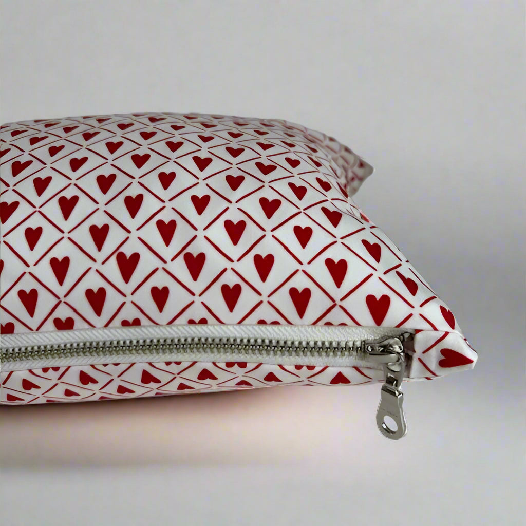 sweet hearts organic cotton Love lumbar pillow. Made with love in Canada, this whimsical pillow adds a touch of fun and comfort! Just the right size to tuck under your neck, it is oh-so-soft and perfect for reading or napping. 10 18 inches with white exposed zipper.