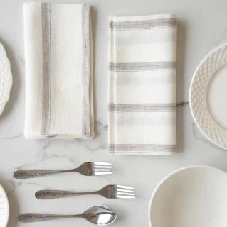 Beautifully crafted in Oeko-Tex linen, these light weight napkins have an off-white base with  sand tone and black vertical stripes. Perfect for fancy or fuss free tables, these napkins are sustainable, absorbent, lint free and gorgeous!   100% linen Size is 18x18" Designed in Canada and made in Europe  Machine washable