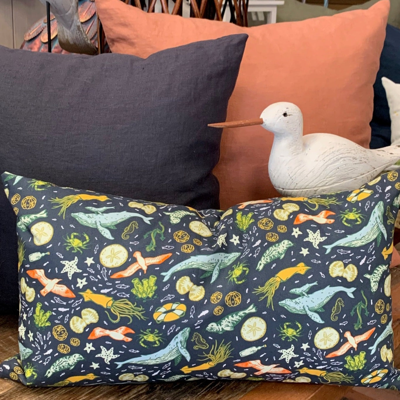 This soft organic cotton pillow cover depicts the diverse marine life off the B.C. Pacific coast. This pillow has an exposed zipper that contrast with shades of blue and pops of colour. A beautiful accent in any home or cottage.  100% Organic Cotton, handmade in Canada.  Size 14" x 20"   Machine wash warm, low heat dryer   Made to order. 
