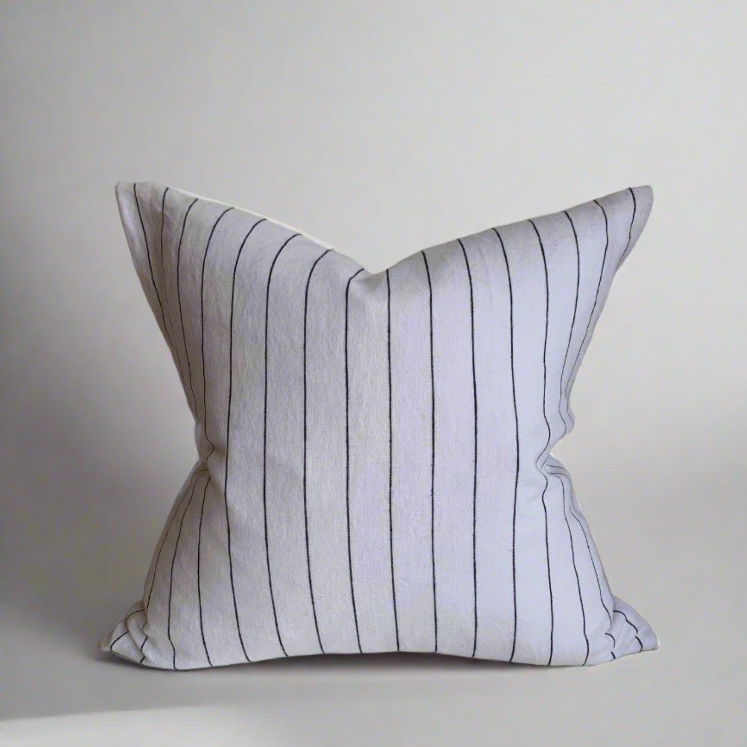 Mixing French countryside charm with modern farmhouse style, our elegant yet casual Pinstripe Linen Pillow Covers feature 100% Oeko-Tex® certified linen and an exposed YKK zipper. The fabric has been specially washed for a soft touch and minimal shrinking, making it a timeless addition to any home or cottage. Made to order. These pillow covers are handmade in Canada. Pillow cover only - insert not included. Size: 18 x 18