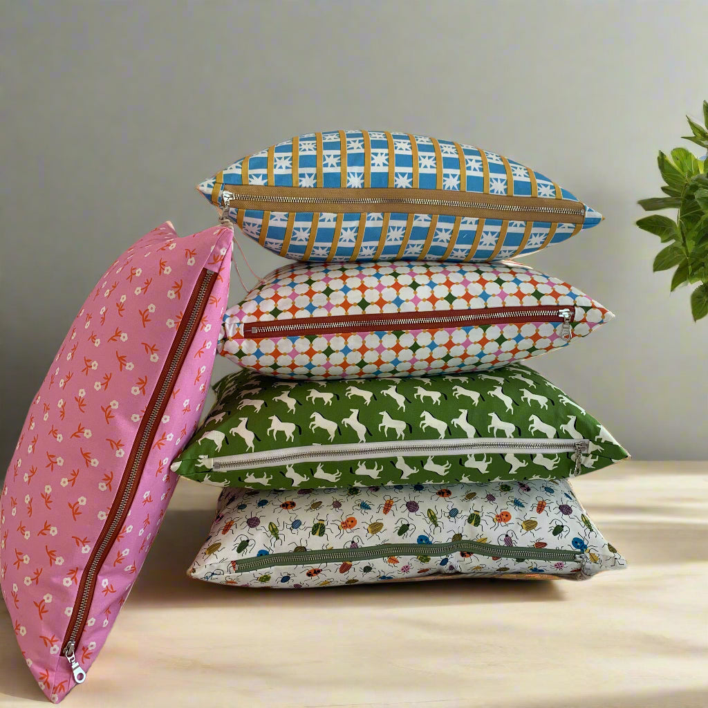 Hand made in Canada, these fabrics of bugs, ponys, and floral pattern fabrics are crafted from GOTS organic cotton. Its softness is unbeatable, and the exposed cream zipper adds a unique touch that pairs perfectly with the vibrant green and bold black accents. Introduce a little whimsy and fun to your home, cottage, bunkie, or sunroom.