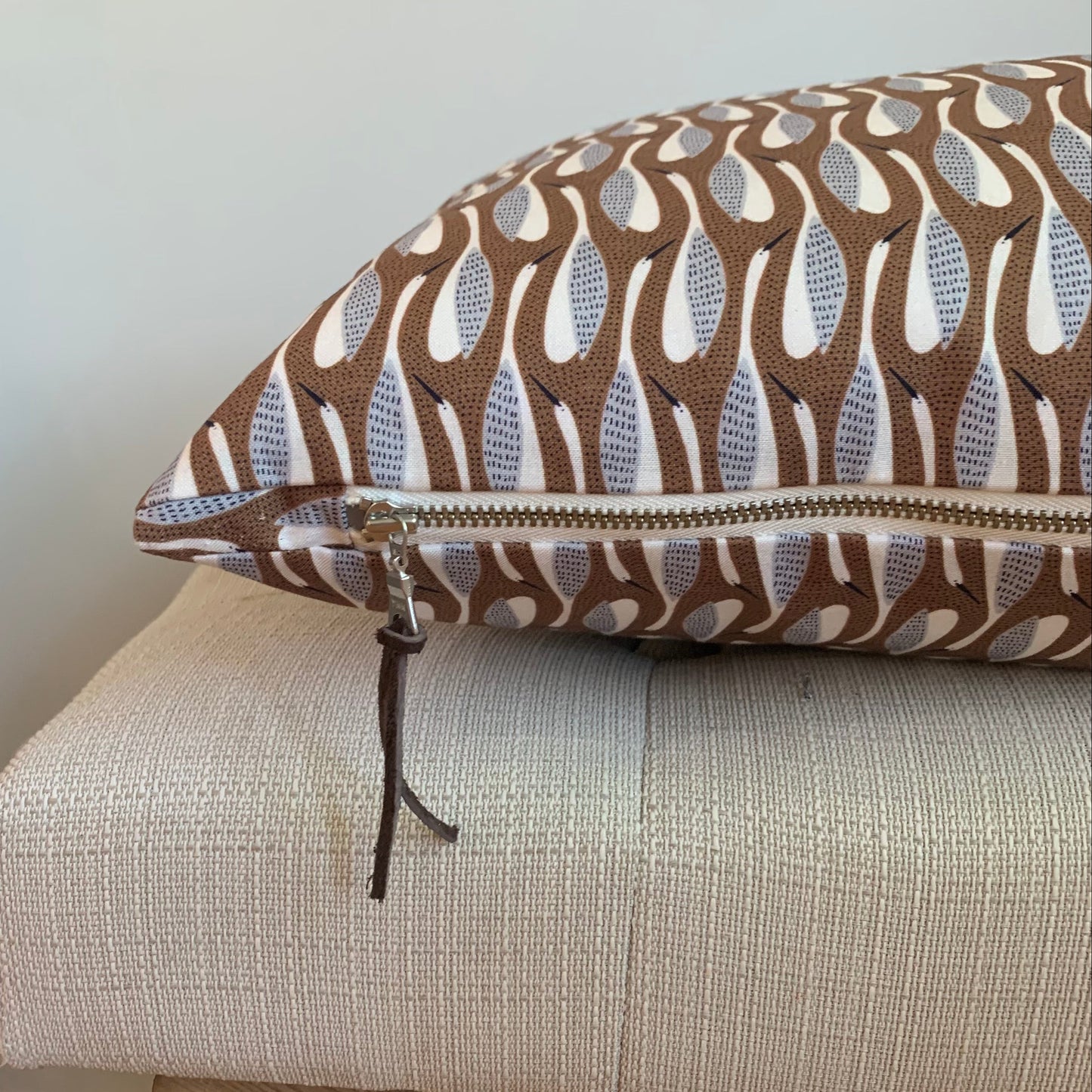 Organic cotton grey goose pattern pillow with cream exposed zipper.