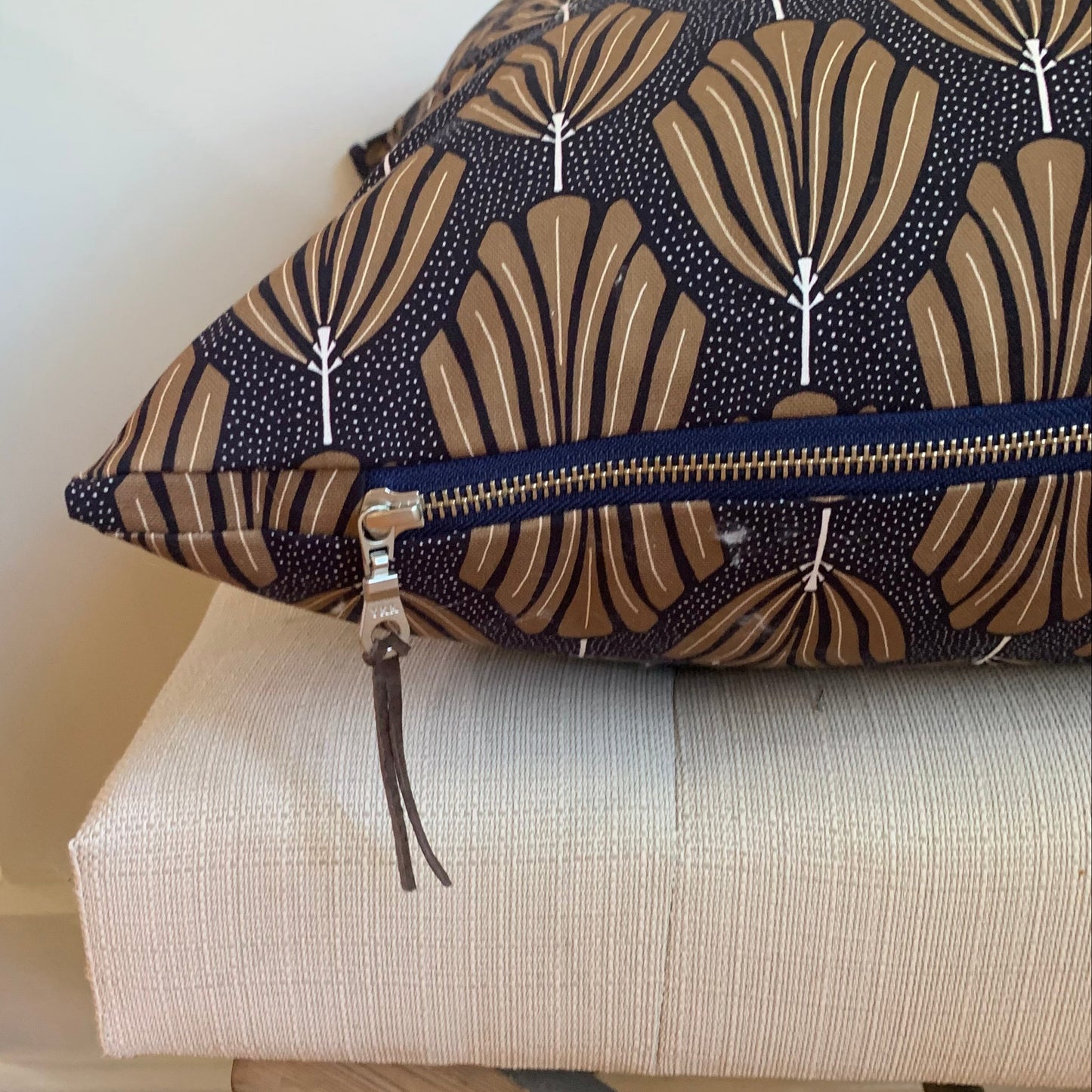 Organic cotton retro large leaf pattern pillow with navy exposed zipper.
