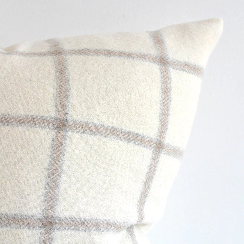 This beautiful pillow is cozy and a show stopper with graphic checks on a white wool background. The light tones make it a versatile option for any decor. Made of 55% Alpaca 45% Wool Size: 22x22" Designed and made in Canada