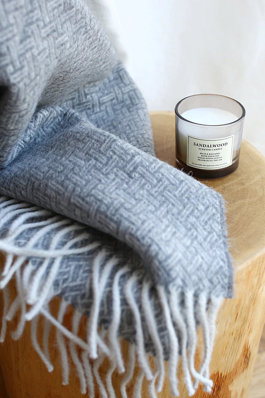 This sustainable and oh so soft basket-weave design is a modern twist on a traditional look. Super soft Alpaca wool is sustainable and beautiful! Did you know that Alpaca fibres are softer, warmer and more durable than other natural fibres? And, Alpaca fibres are smooth so there is less pilling and look new for a long time. Made of 55% Alpaca 45% Wool oversized at 55x78" Designed in Canada and crafted in Peru heavy-weight at 970 GSM