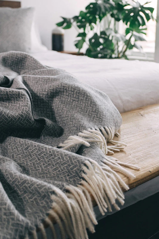 This sustainable and oh so soft basket-weave design is a modern twist on a traditional look. Super soft Alpaca wool is sustainable and beautiful! Did you know that Alpaca fibres are softer, warmer and more durable than other natural fibres? And, Alpaca fibres are smooth so there is less pilling and look new for a long time. Made of 55% Alpaca 45% Wool oversized at 55x78" Designed in Canada and crafted in Peru heavy-weight at 970 GSM