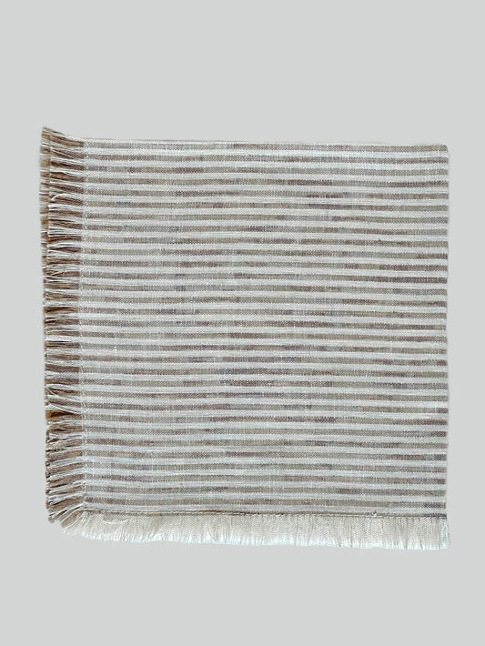 Beautifully crafted in Oeko-Tex linen, these soft beige and white  napkins have subtle thin stripes and fringed edges. Perfect for fancy or fuss free tables, these napkins are sustainable, absorbent, lint free and gorgeous! 100% linen Size is 19x19" Designed and made in Canada. Machine washable