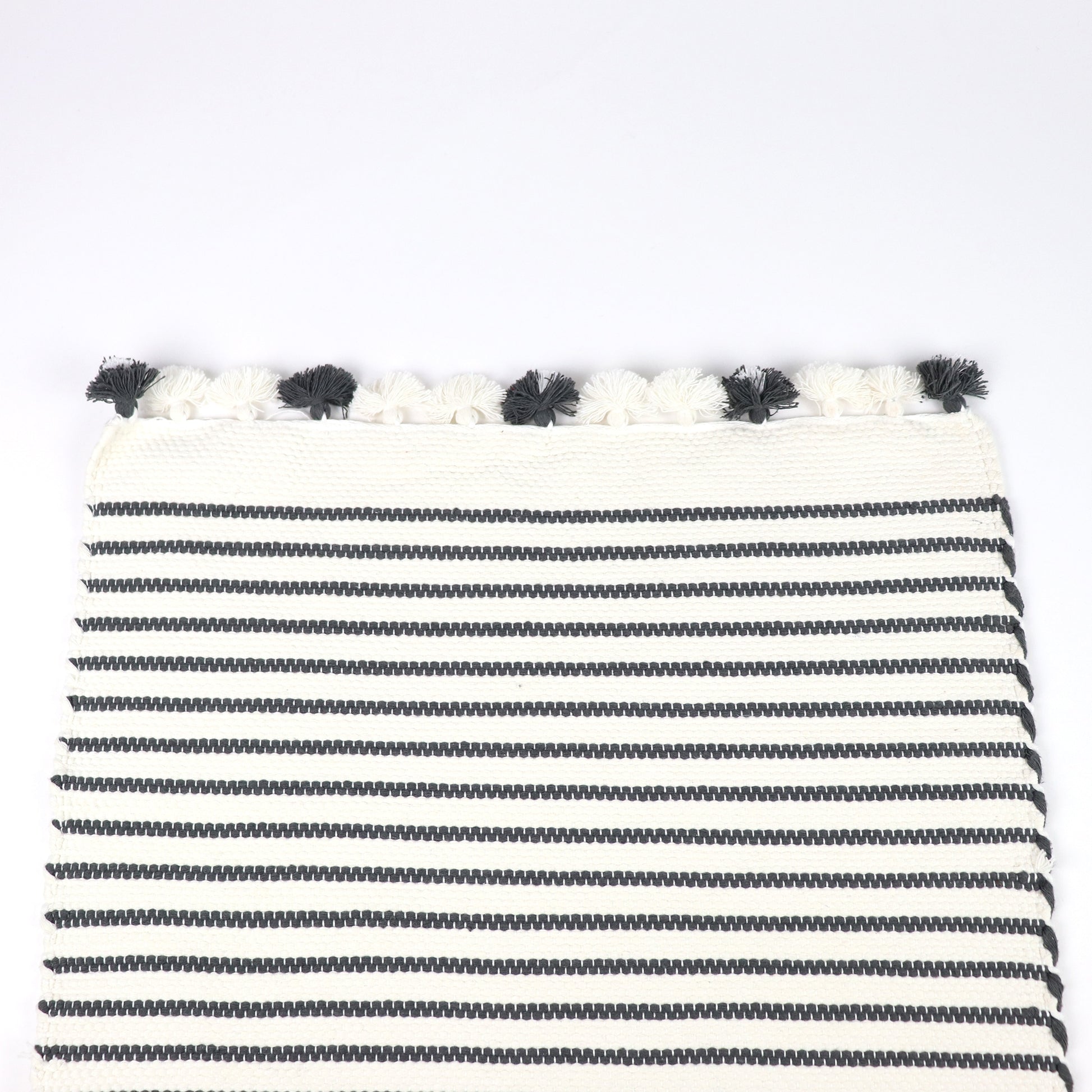 Ethically produced 100% cotton bath mat white with black stripes and small tassels