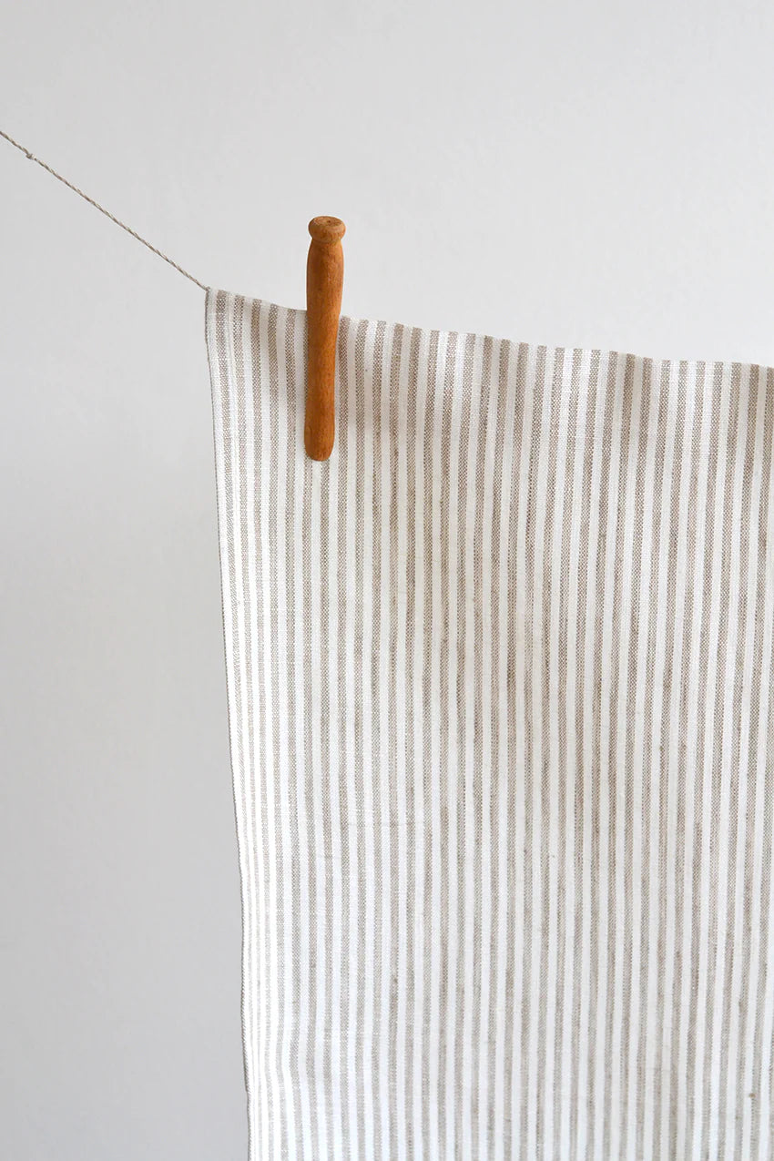 Thin vertical stripes in soft beige give this linen tea towel a subtle and stylish look. The perfect match for any kitchen. Made from sustainable European linen 100% European linen Size 18 x27 inches Proudly designed and made in Canada Machine washable