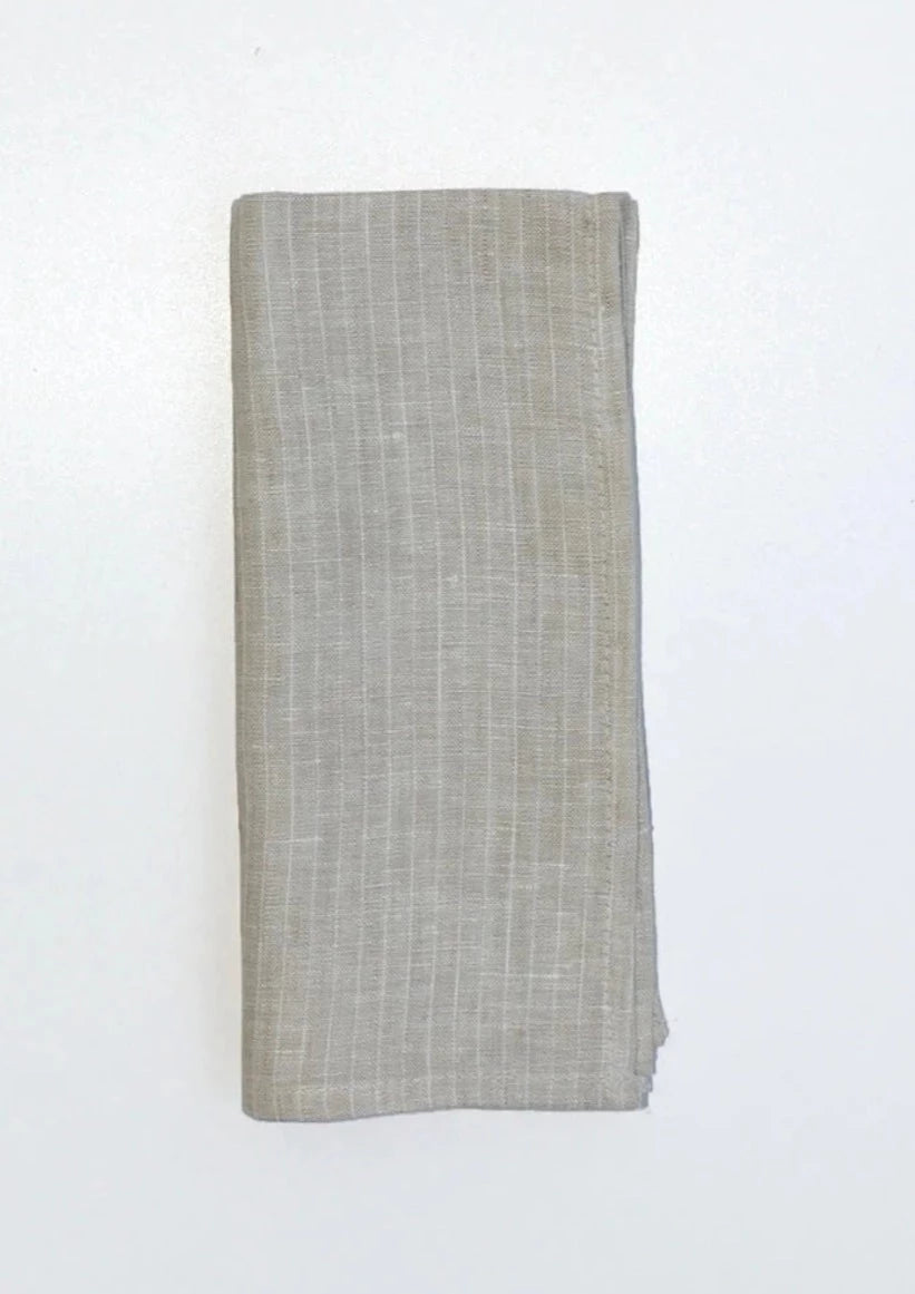 Beautifully crafted in Oeko-Tex linen, these soft beige napkins have subtle thin stripes that will grace any table. Perfect for fancy or fuss free tables, these napkins are sustainable, absorbent, lint free and gorgeous!   100% linen Size is 18x18" Designed in Canada and made in Europe  Machine washable