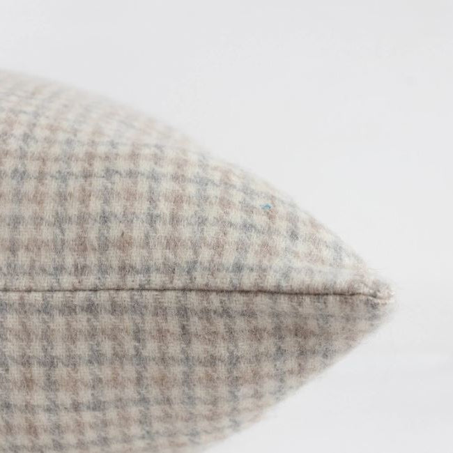 Made in Canada, this beautiful wool pillow cover is thick and soft with shades of Light Grey, Ivory &amp; Tan, and layers seamlessly with various colors and textures. Made from Responsible Alpaca Standard (RAS) wool, it is not only incredibly soft but ethically produced and built to withstand the test of time. Sustainable living, beautifully crafted.&nbsp;

Measurements: 22"W x 22"L
Materials: RAS 55% Alpaca 45% Wool
Designed and Hand-made in Canada