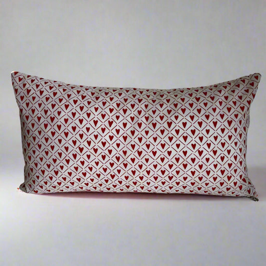 sweet hearts organic cotton Love lumbar pillow.&nbsp; Made with love in Canada, this whimsical pillow adds a touch of fun and comfort! Just the right size to tuck under your neck, it is oh-so-soft and perfect for reading or napping.&nbsp;