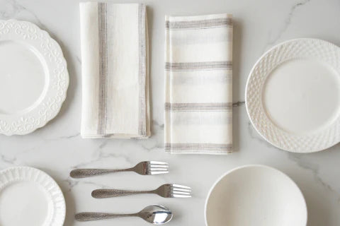 Beautifully crafted in Oeko-Tex linen, these light weight napkins have an off-white base with  sand tone and black vertical stripes. Perfect for fancy or fuss free tables, these napkins are sustainable, absorbent, lint free and gorgeous!   100% linen Size is 18x18" Designed in Canada and made in Europe  Machine washable