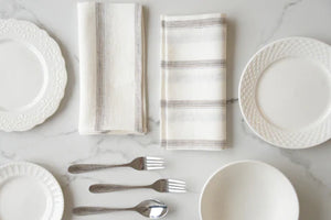 Beautifully crafted in Oeko-Tex linen, these light weight napkins have an off-white base with  sand tone and black vertical stripes. Perfect for fancy or fuss free tables, these napkins are sustainable, absorbent, lint free and gorgeous!   100% linen Size is 18x18" Designed in Canada and made in Europe  Machine washable
