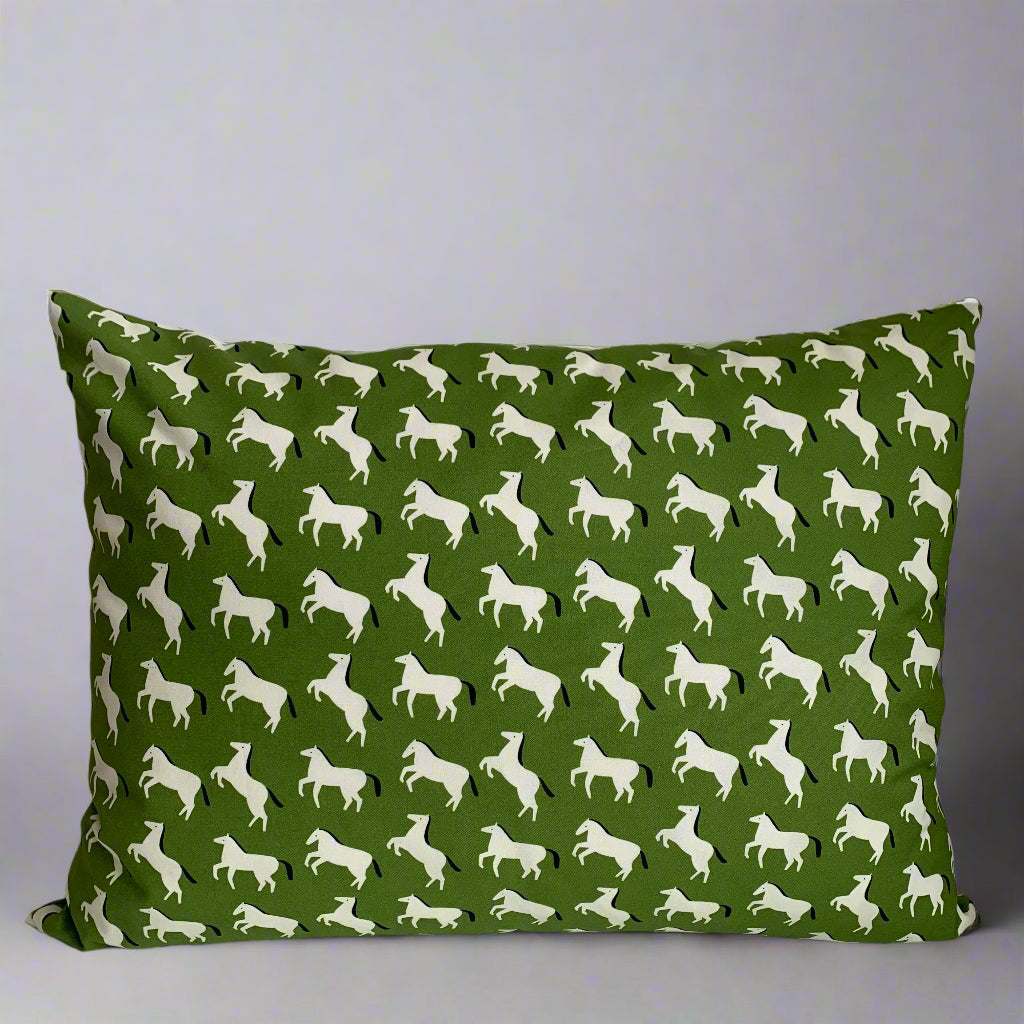 Hand made in Canada, this super cute pony pattern fabric is crafted from GOTS organic cotton. Its softness is unbeatable, and the exposed cream zipper adds a unique touch that pairs perfectly with the vibrant green and bold black accents; Introduce a little whimsy and fun to your home, cottage, bunkie, or sunroom. Size 14 x 20 inches