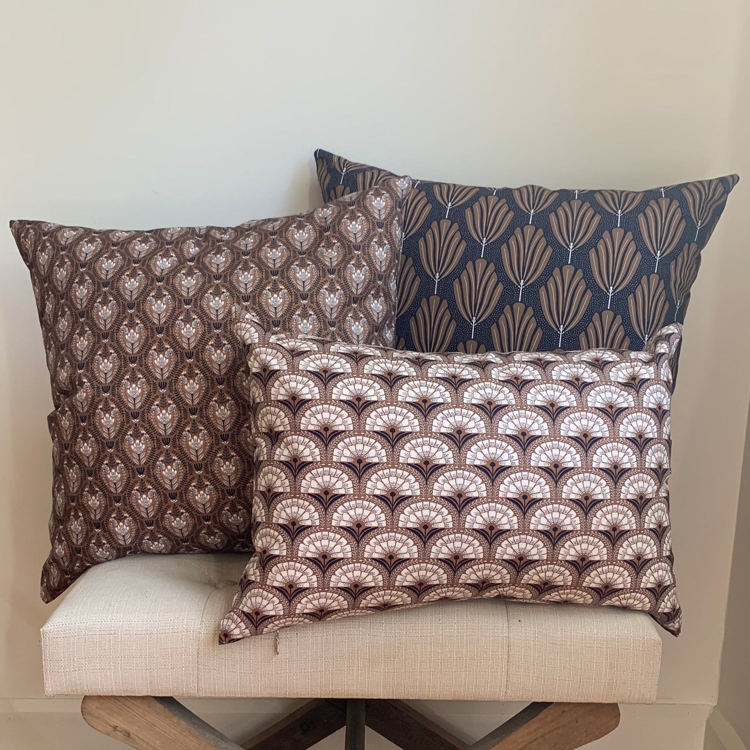 Organic Cotton Patterned cushions on a chair with a wooden floor and white wall in the background