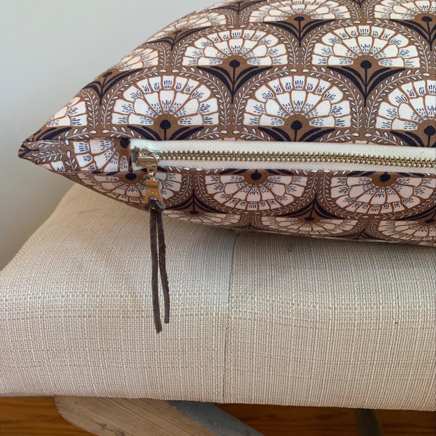 Organic cotton retro pattern pillow with cream exposed zipper. 