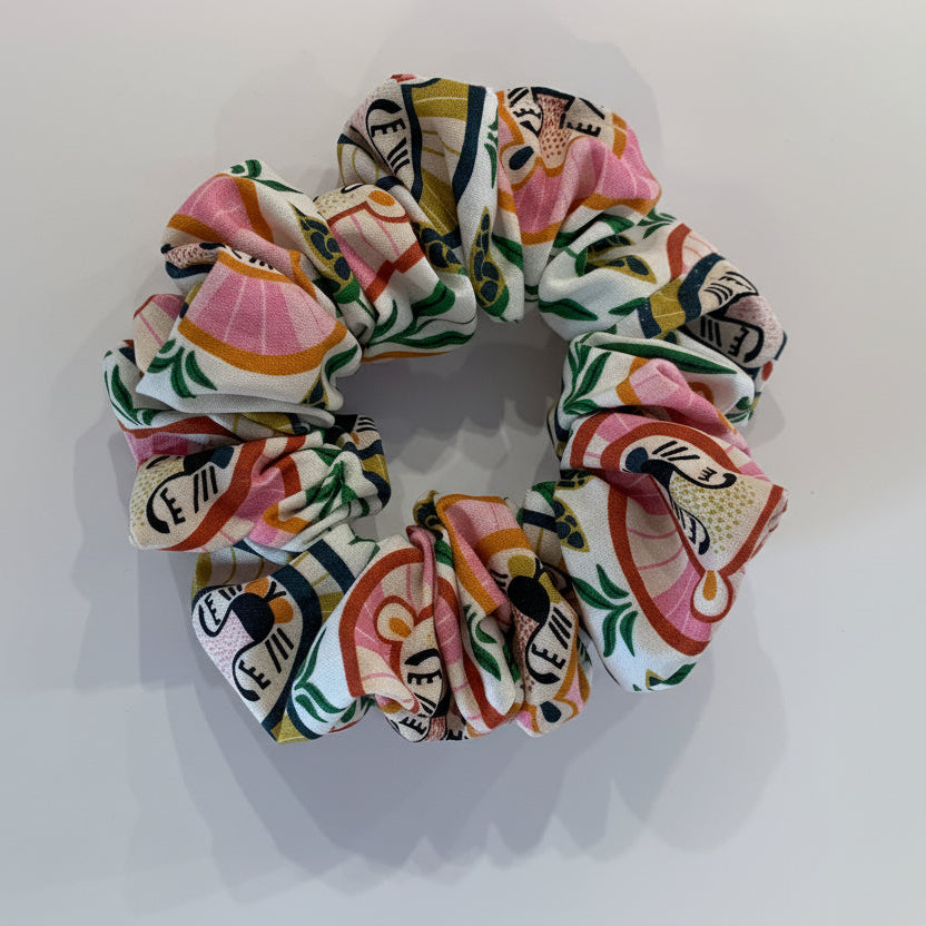 Colorful scrunchie with lion head patterns on a white background