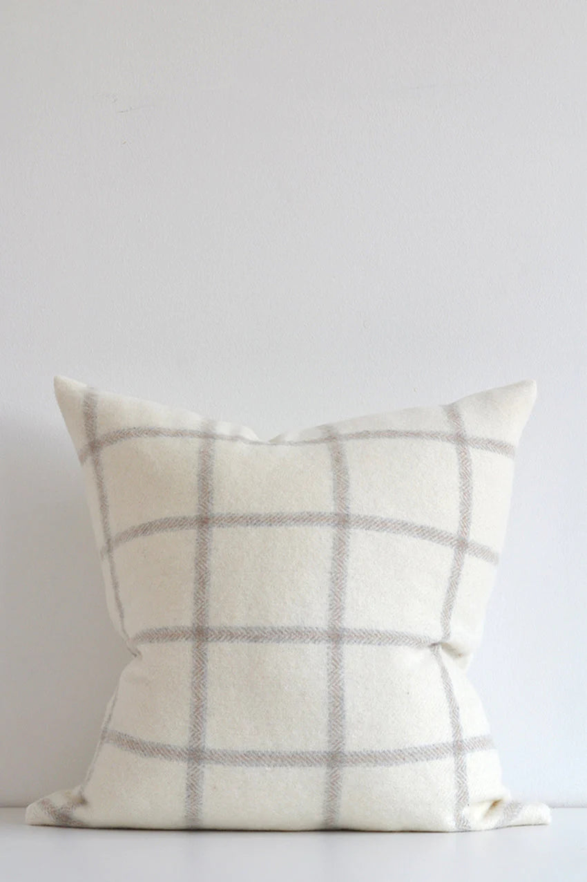 This beautiful pillow is cozy and a show stopper with graphic checks on a white wool background.  The light tones make it a versatile option for any decor.  Made of 55% Alpaca 45% Wool Size: 22x22" Designed and made in Canada