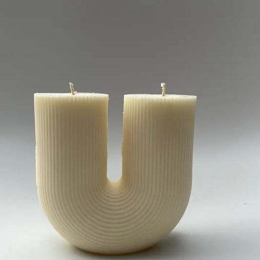 Handcrafted in Canada, this hand-poured soy candle has a beautiful, elegant U shape. With stunning attention to detail, this candle adds a touch of modern elegance to your home decor.

These candles are handmade for decorative purposes using soy wax. Remember to place your candles on a heat proof dish if you wish to light them and never leave your candle unattended.

The use of soy wax can sometimes cause frosting to occur on the candle over a period of time. Candles are hand-poured, you may see variations.