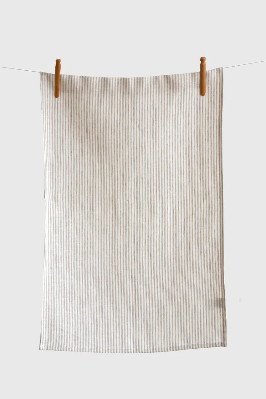 Thin vertical stripes in soft beige give this linen tea towel a subtle and stylish look. The perfect match for any kitchen. Made from sustainable European linen 100% European linen Size 18 x27 inches Proudly designed and made in Canada Machine washable