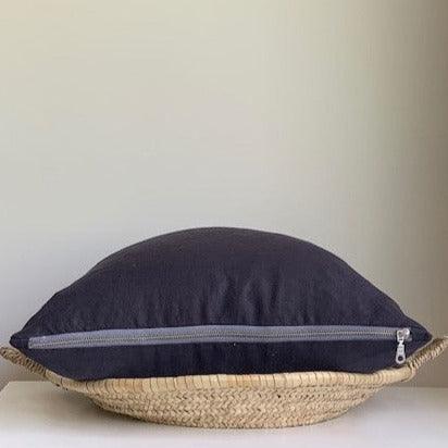 Oeko-Tex certified linen pillow cover in Graphite Blue with a Seal Grey contrasting exposed zipper. 